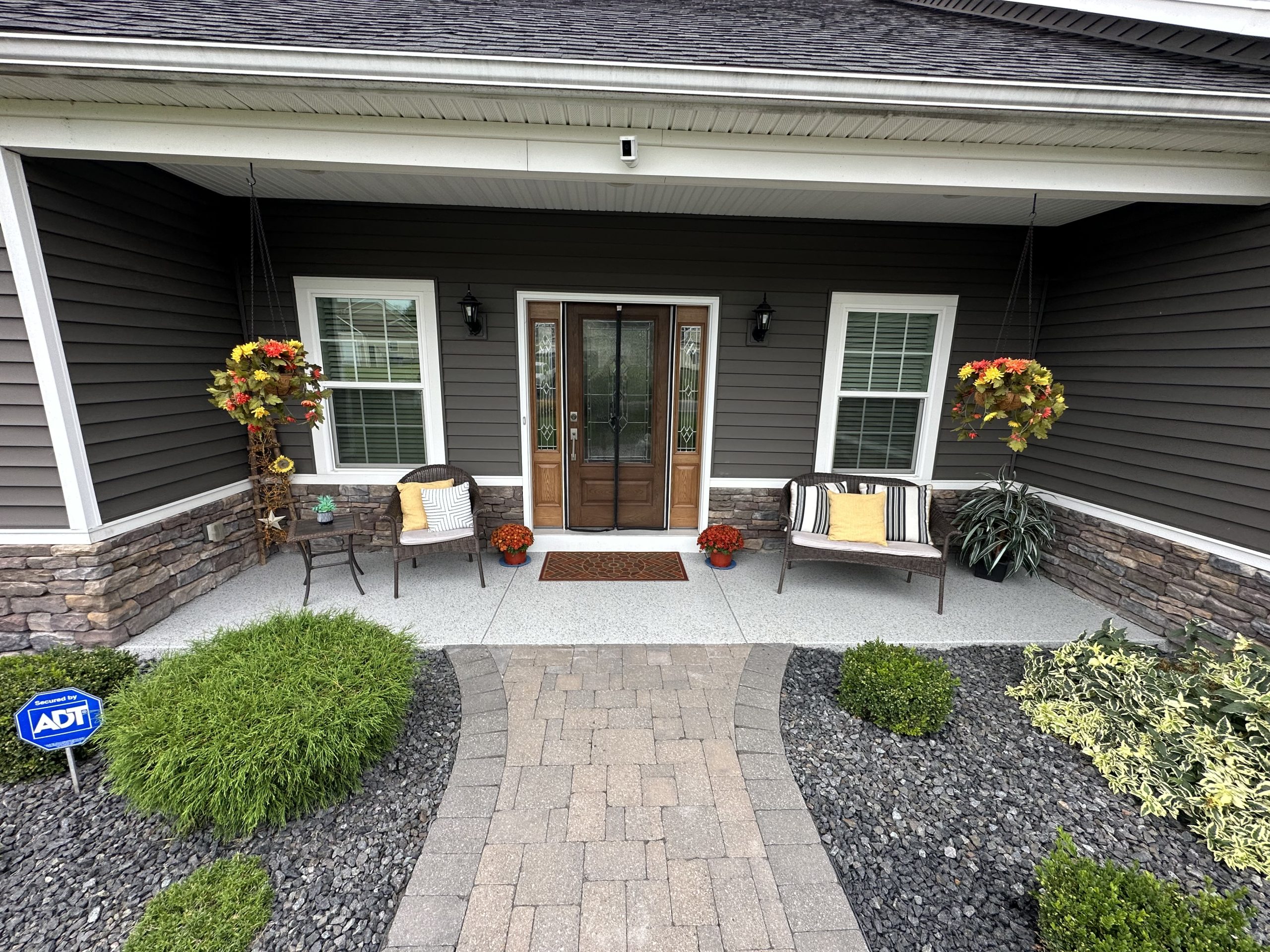 Premium flake floor on a covered porch with chairs and flowers